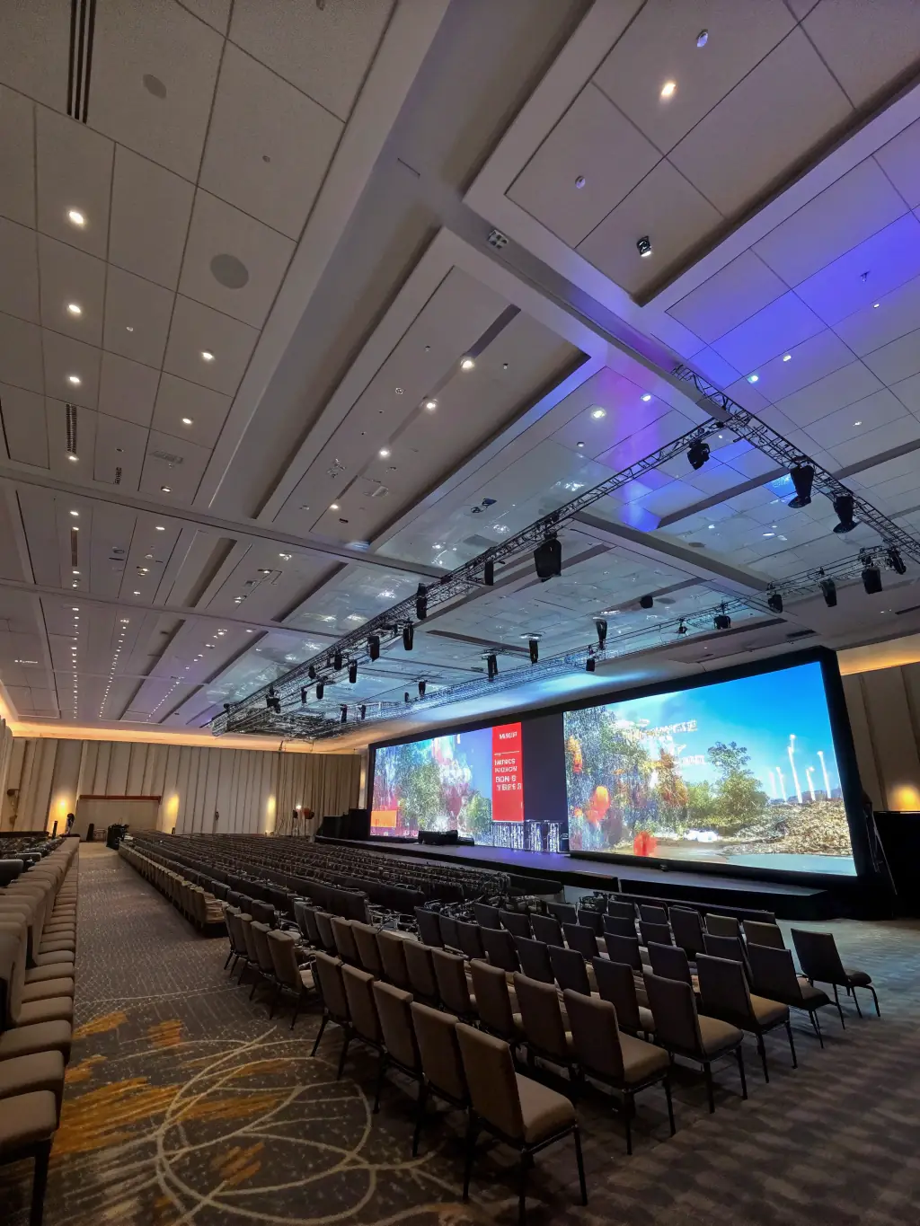 A photograph of a modern conference hall filled with attendees listening to a keynote speaker on stage at the 'Innovate North' tech summit in Toronto, Canada.